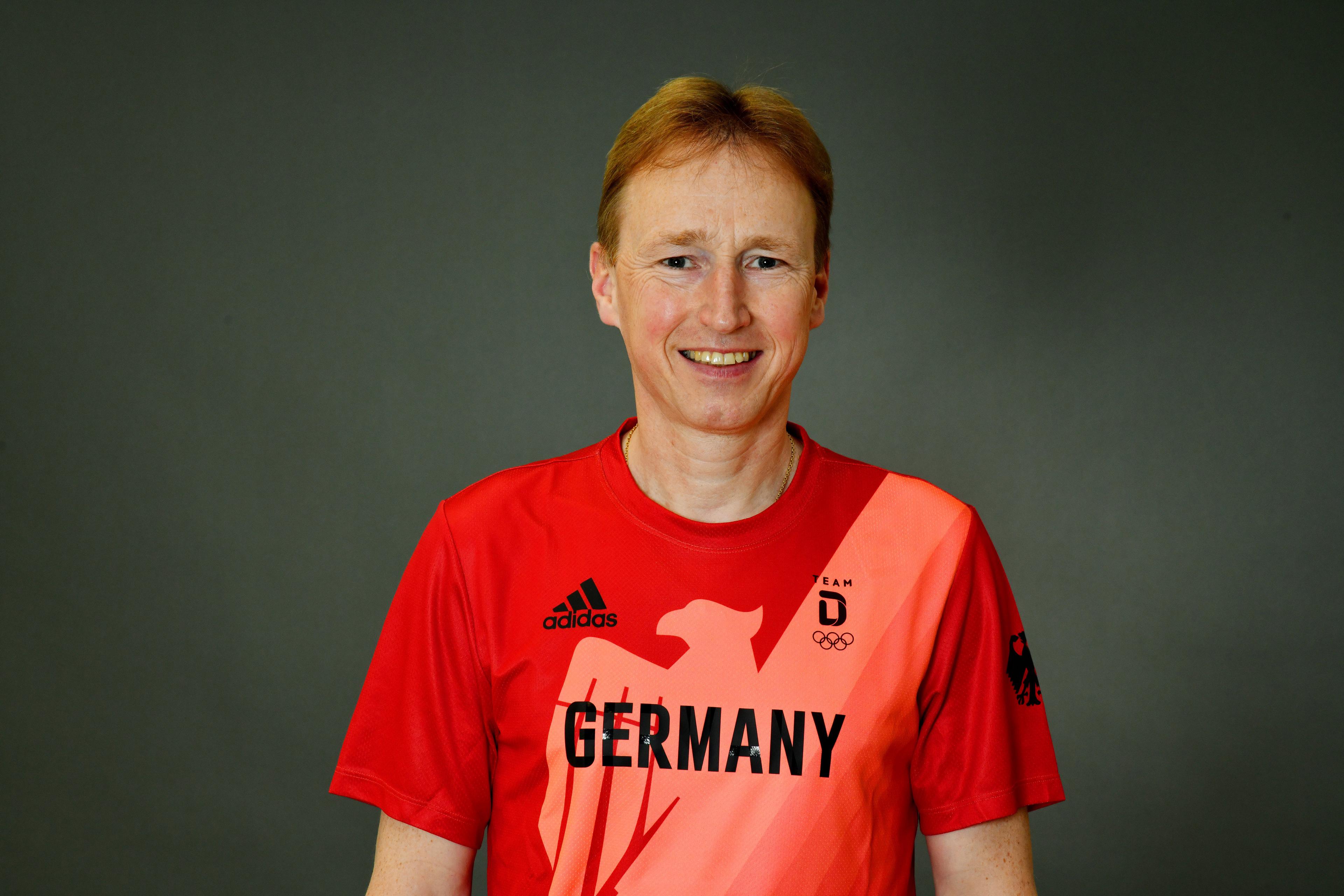 Photo: Portrait shot of Olympic team doctor with the federal eagle emblem on the jacket