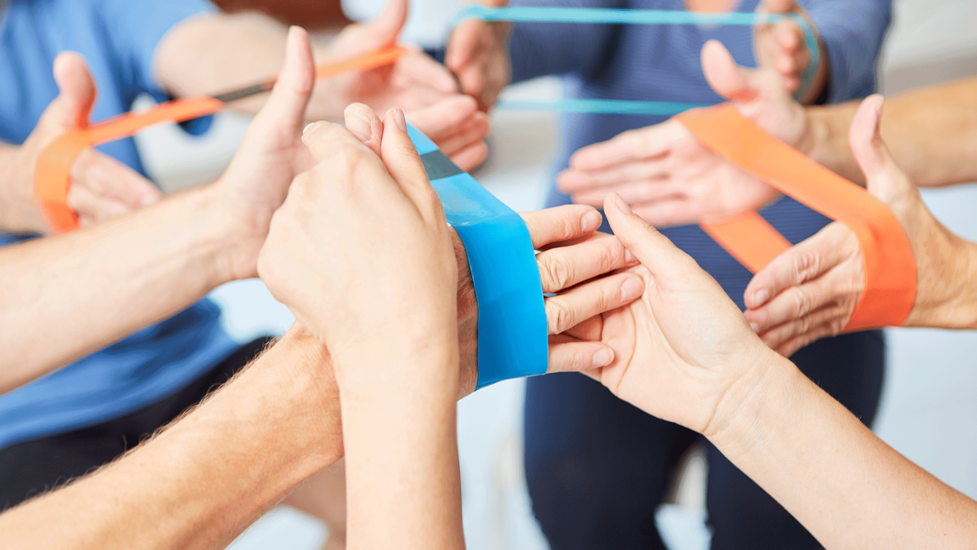 Illustration: The hands of several people in a rehab sport activity